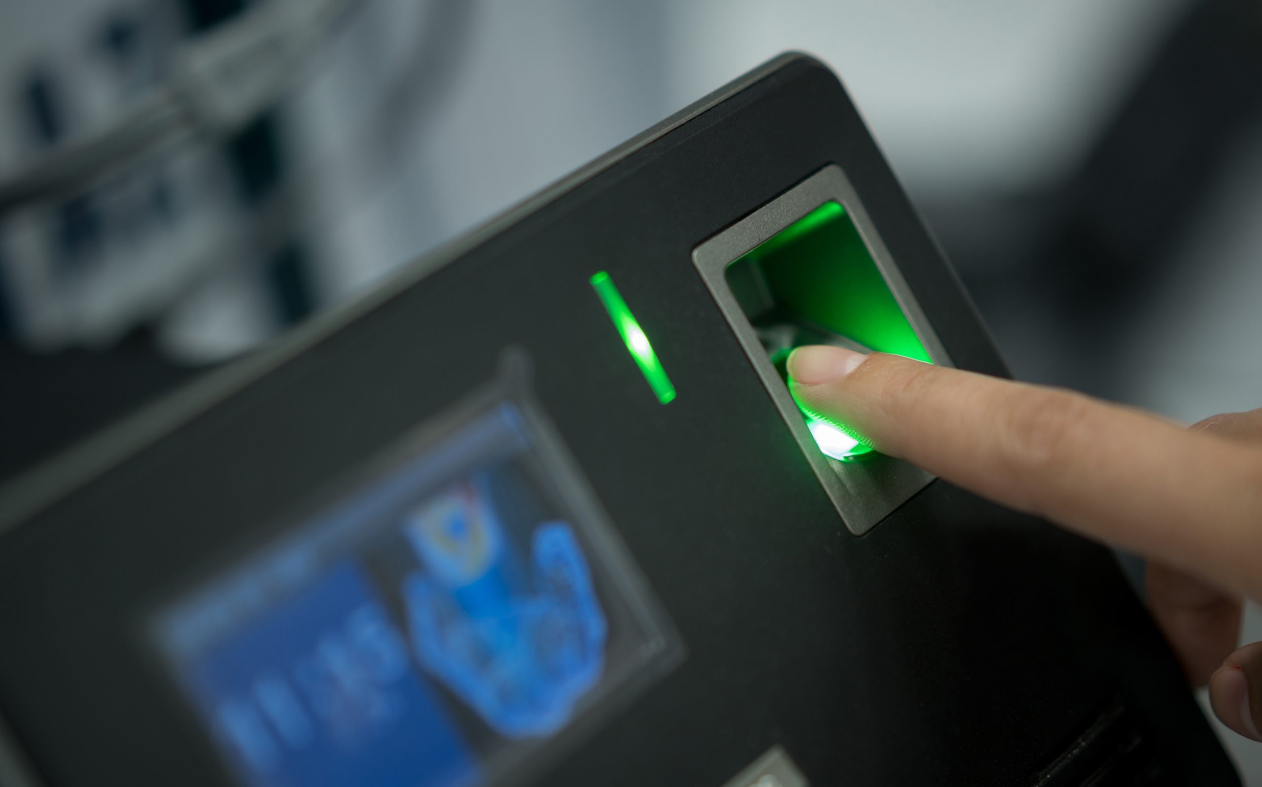 Unrecognizable person putting their finger in a fingerprint scanner